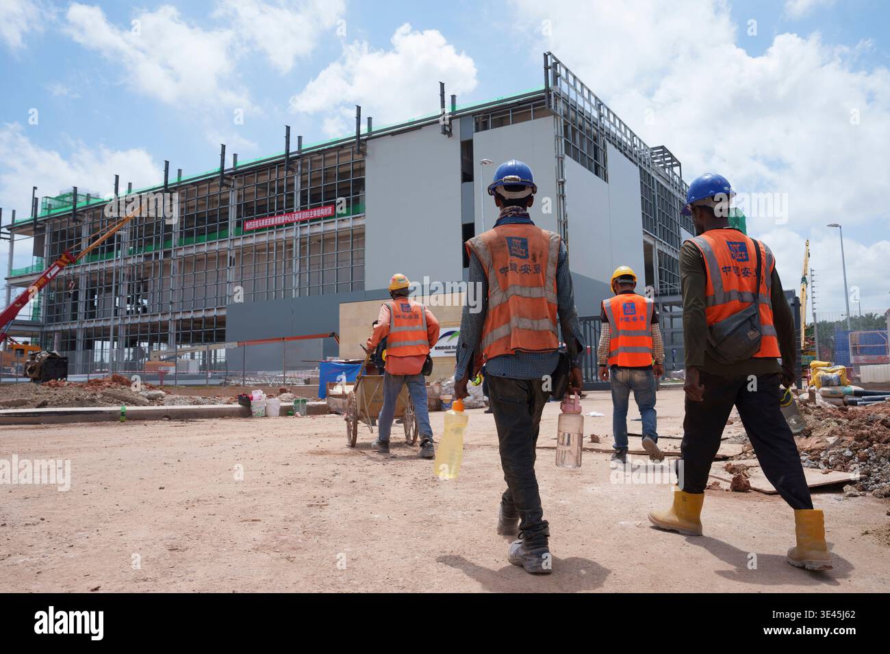 FILE -Construction workers walk to a Data center building under ...