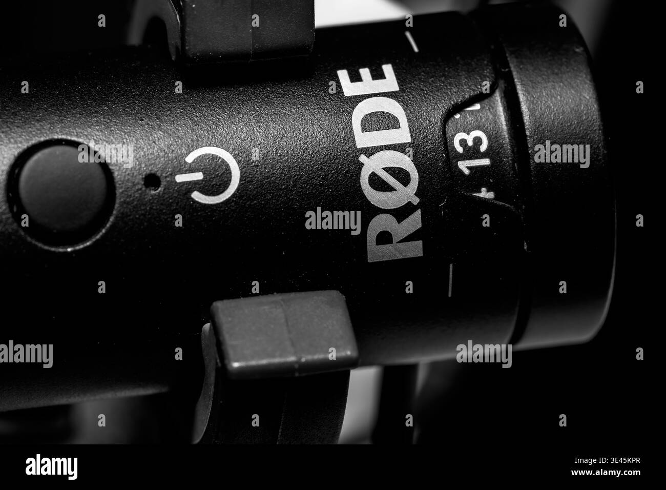 Macro close up of Rode professional microphone showing logo power button and branding on black audio equipment Stock Photo