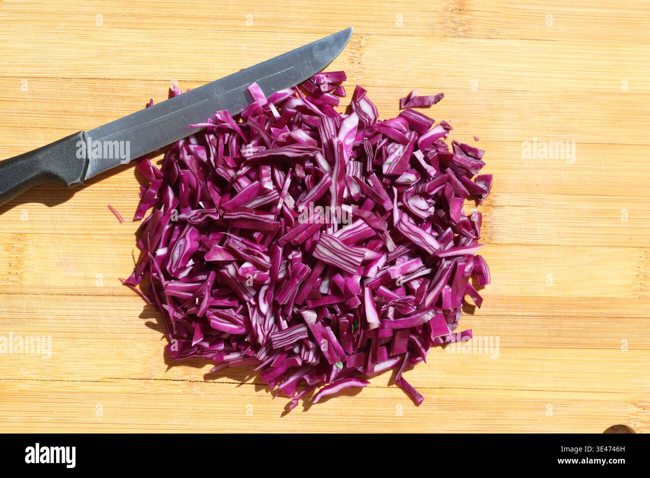 finely chopped red cabbage on the chopping board Stock Photo
