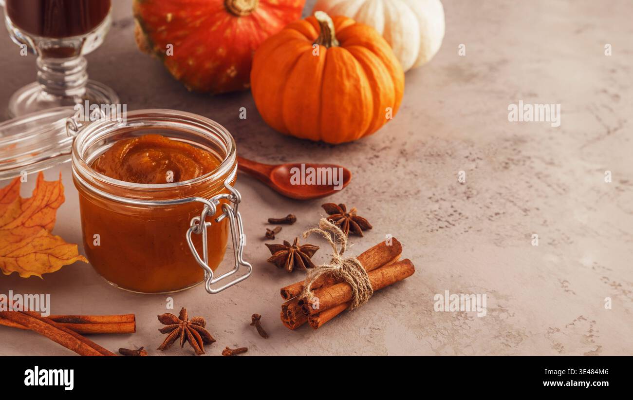 Pumpkin butter on concrete background, selective focus. Stock Photo