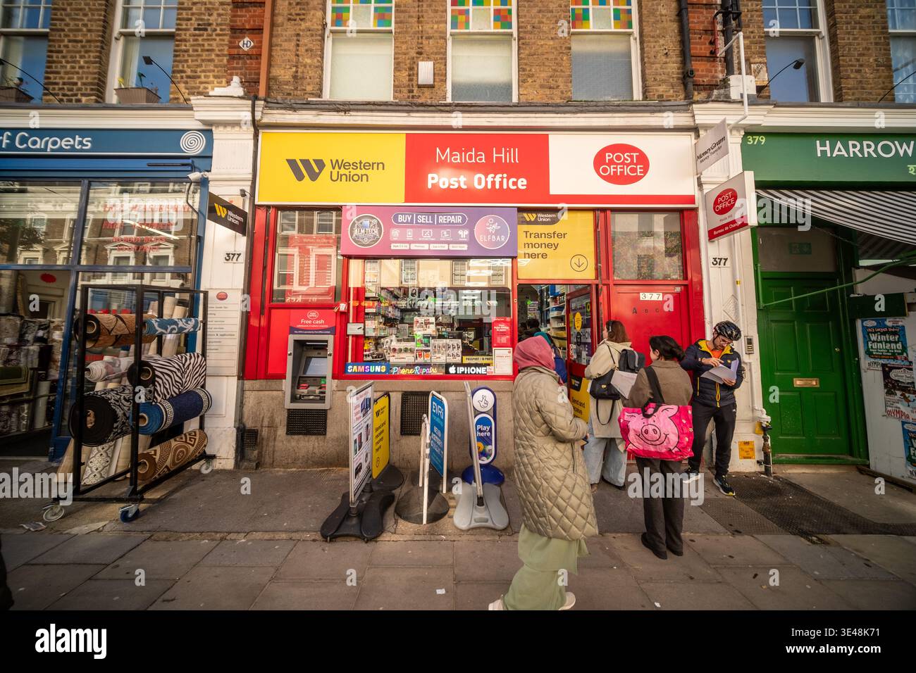 LONDON - FEBRUARY 24, 2026: Maida Hill Post Office with Western Union and phone repair shop on Harrow Road W9 Stock Photo