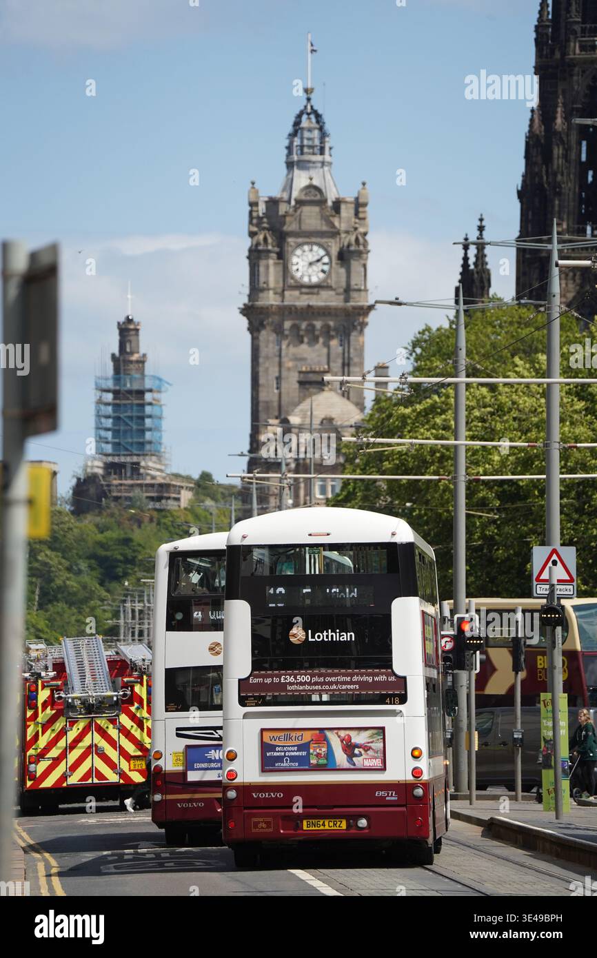 Urban street scene looking east along Princes Street with Lothian Buses ...