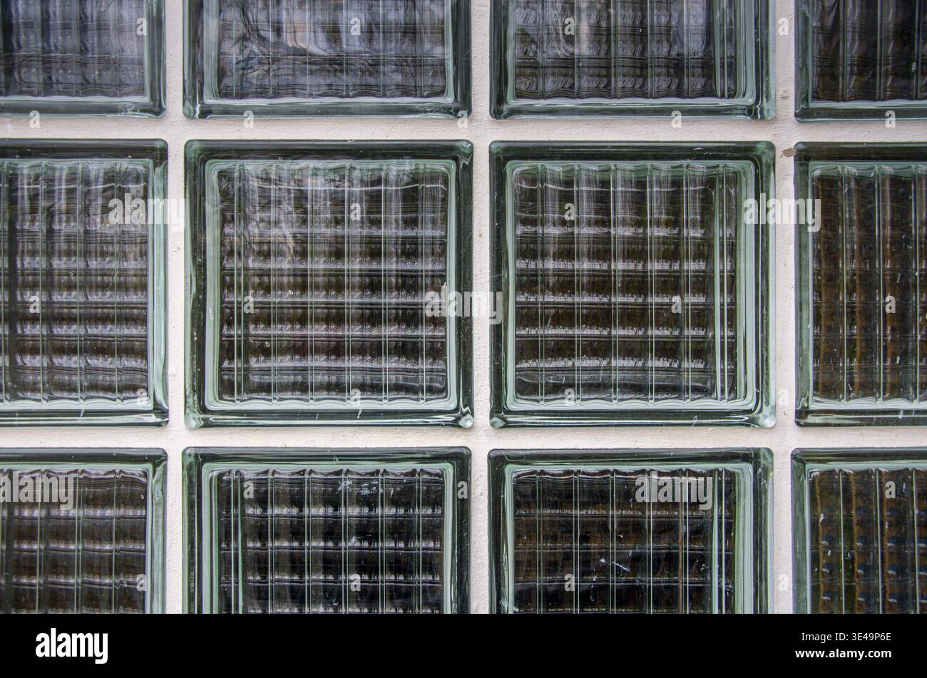 Glass block wall creating a textured pattern with architectural transparency Stock Photo
