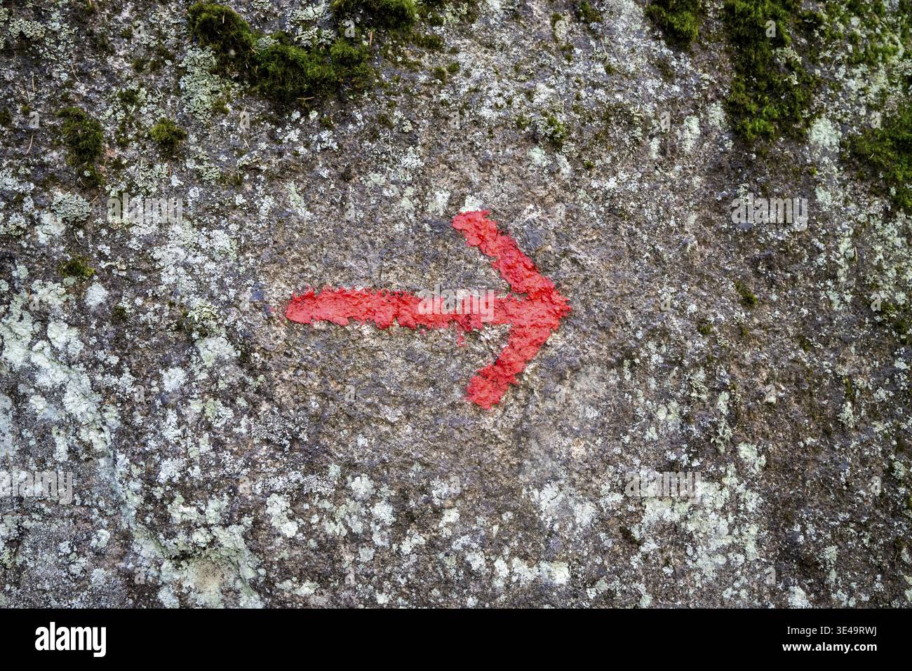 Red arrow on granite stone as texture or background Stock Photo