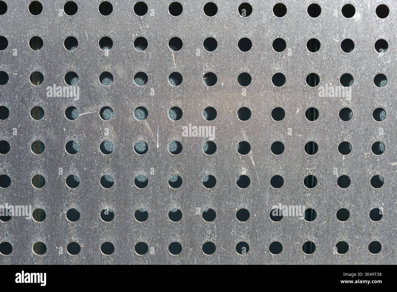 Perforated stainless steel sheet as background or texture Stock Photo
