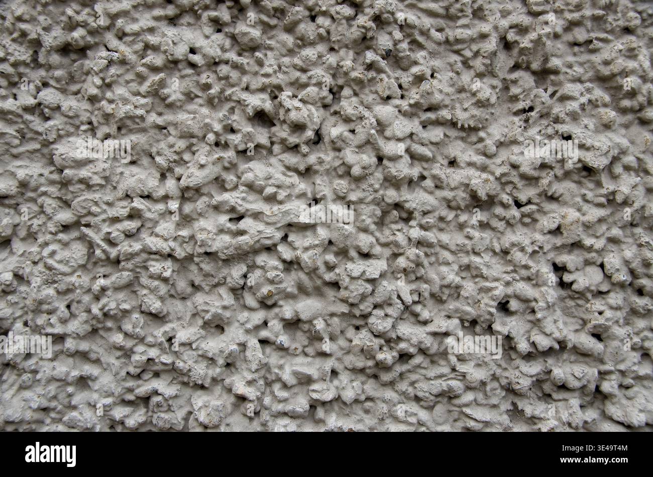 Rough gray stucco wall texture creating an abstract surface background Stock Photo