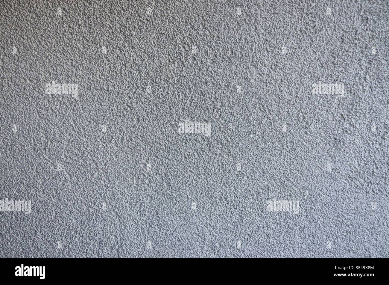 Stucco wall texture creating a gray background with rough, granular surface details Stock Photo