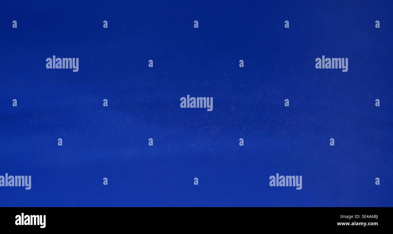 Blue background shows a simple pattern with smooth texture appearing almost like a fabric or wall at different angles and light Stock Photo