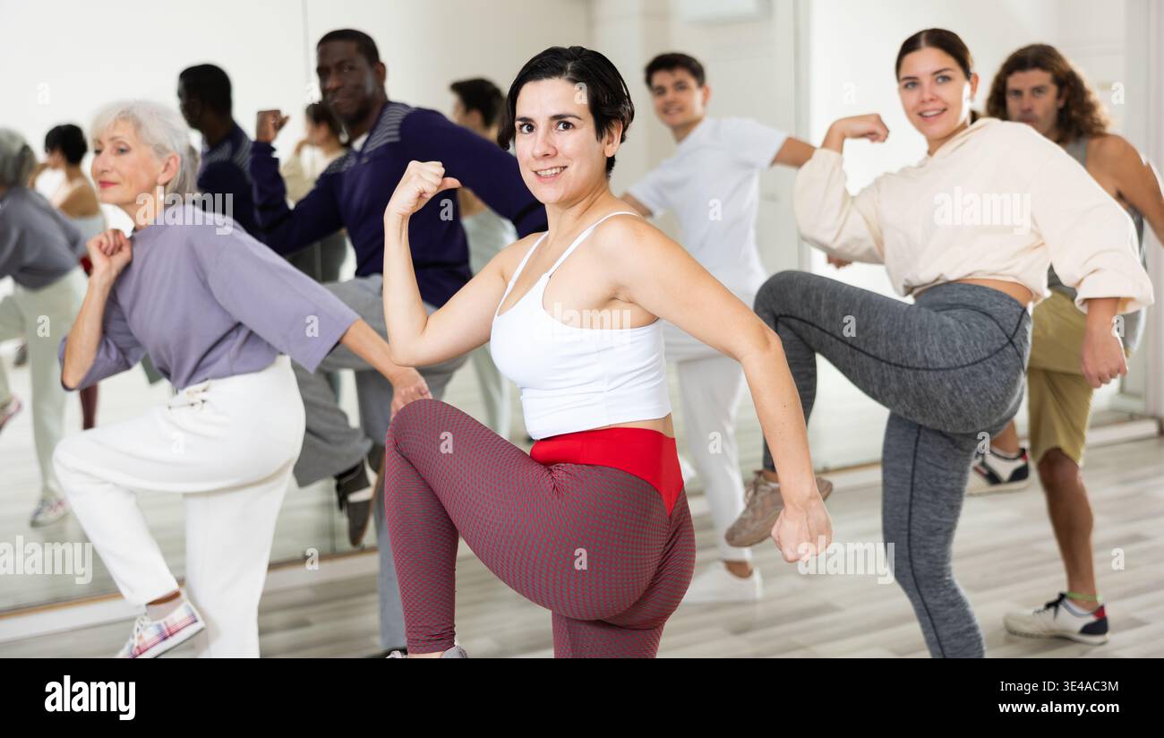 Young Hispanic woman practicing vigorous dance movements Stock Photo
