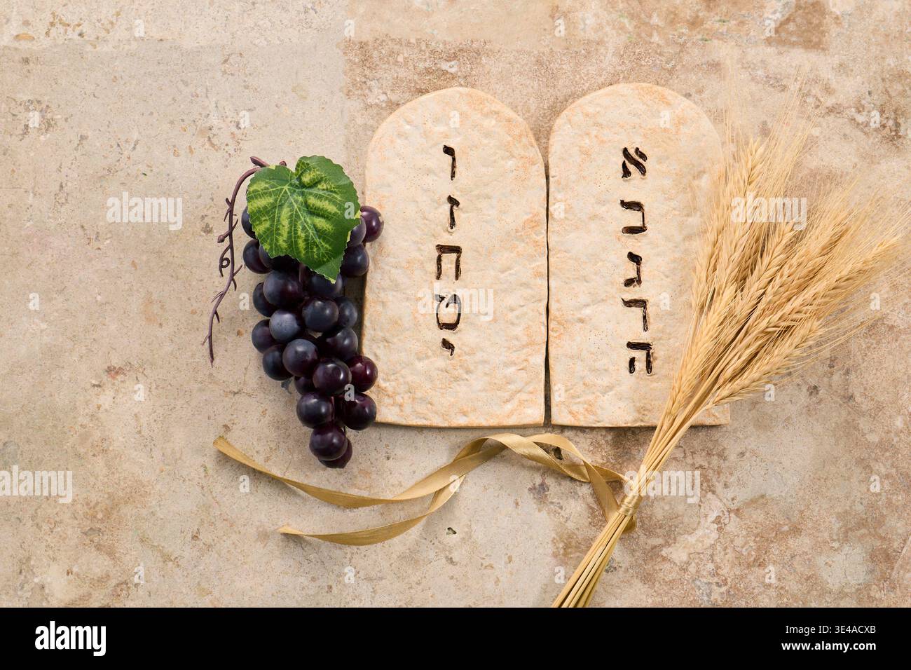 Shavuot ten commandments tablets with grapes and wheat Stock Photo