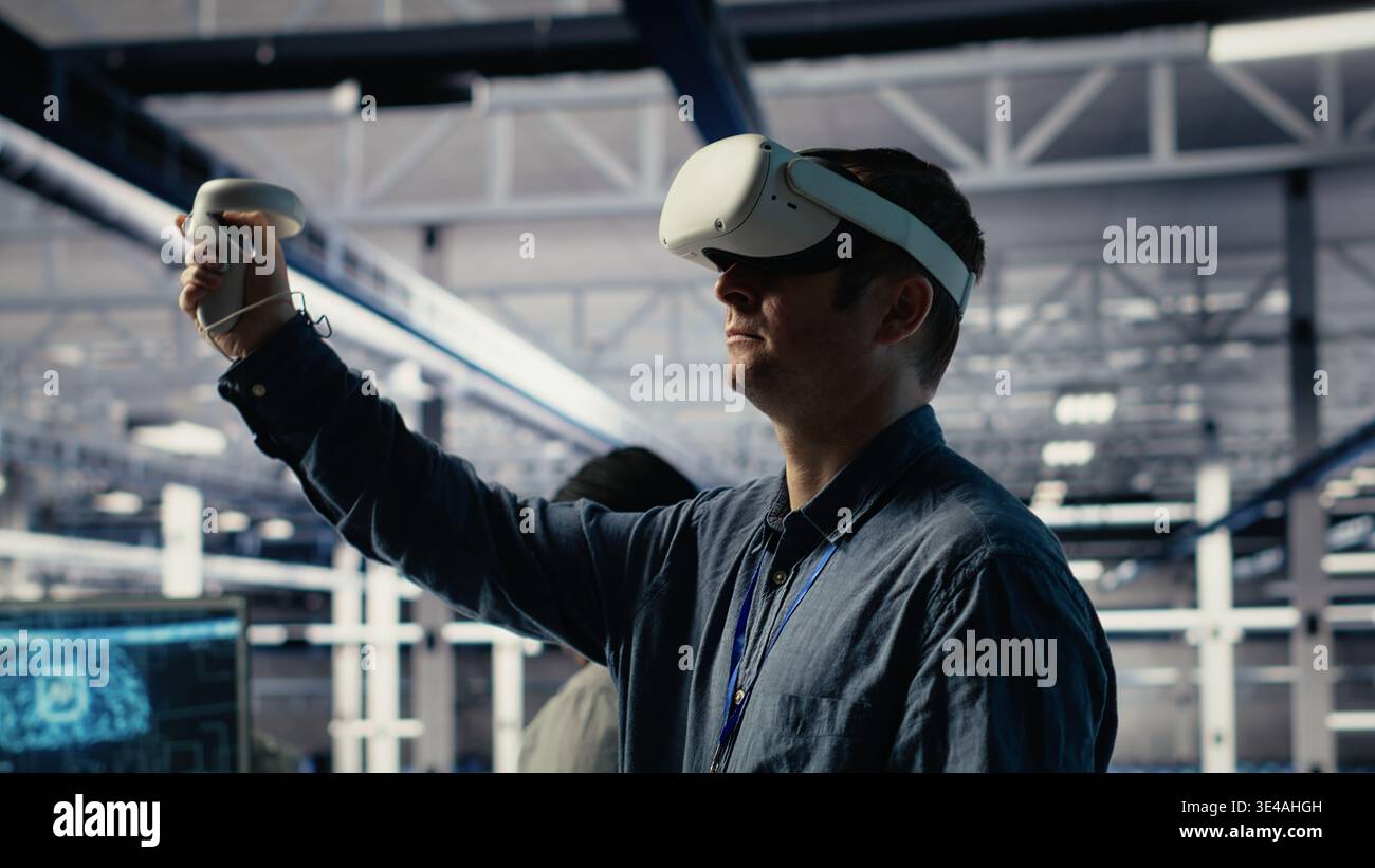 Server farm programmer uses VR headset to install updates and keep AI systems running. Data center employee uses virtual reality tech to write code improving infrastructure output, camera B Stock Photo