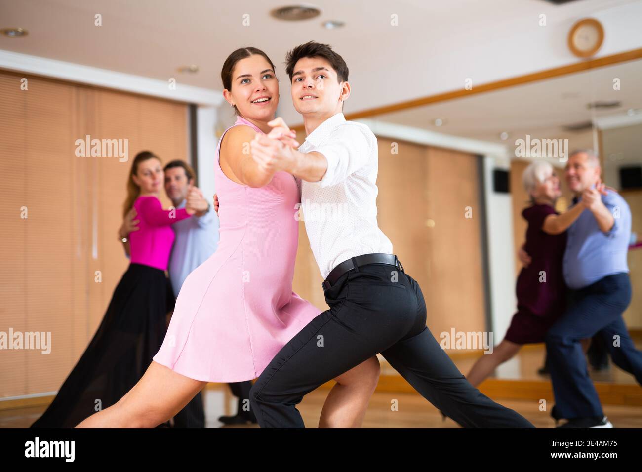 Young pair practicing ballroom dance in dance studio Stock Photo
