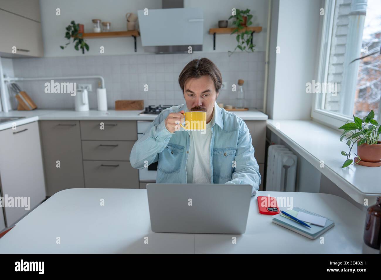 Deep focus, workflow, home office productivity, caffeinated morning routine, digital work immersion. Stock Photo