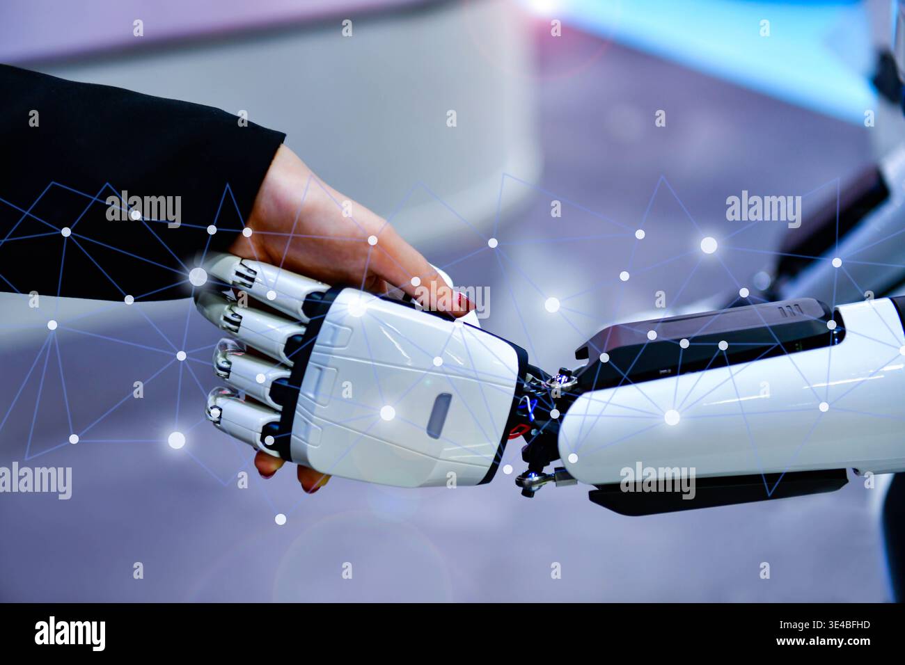 Advanced bionic robotic hand shaking hands with human, symbolizing AI and human collaboration. Stock Photo
