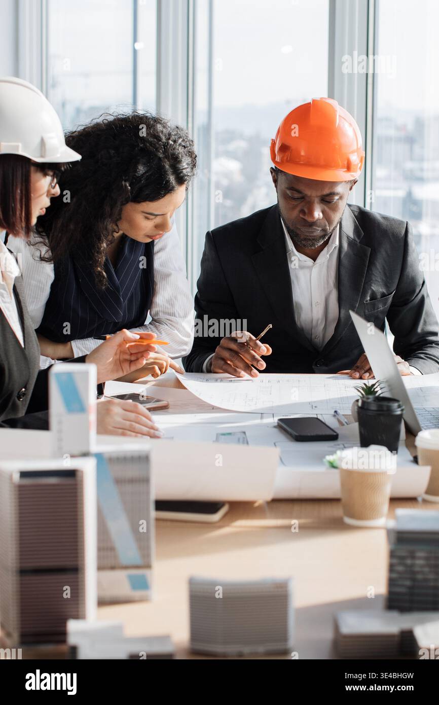 Architects Discussing Blueprints Stock Photo