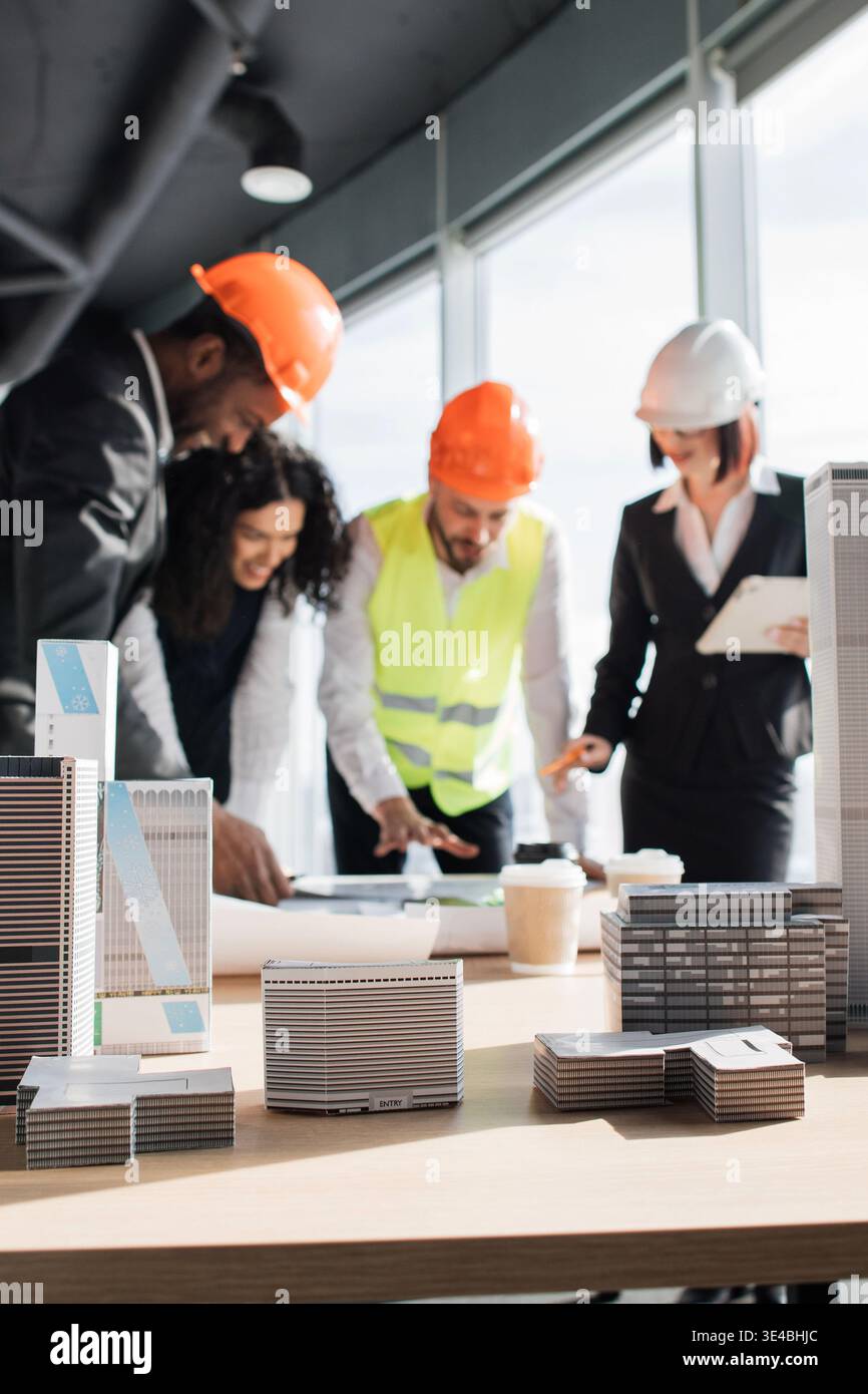 Architects Discussing Building Models Stock Photo