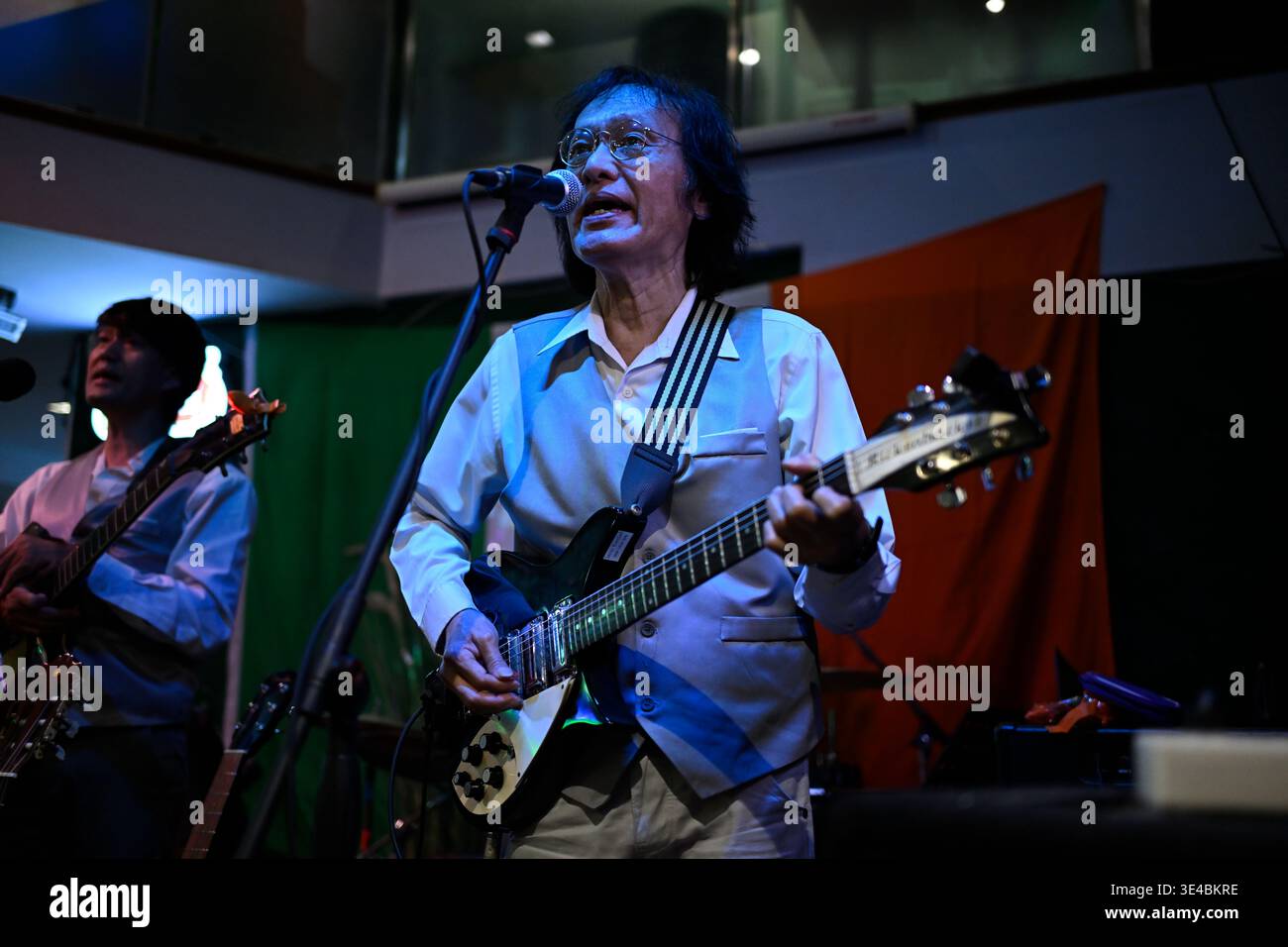 "John Lennon" performs live with the tribute band The Bangkok Beatles in Hua Hin, Thailand. Stock Photo