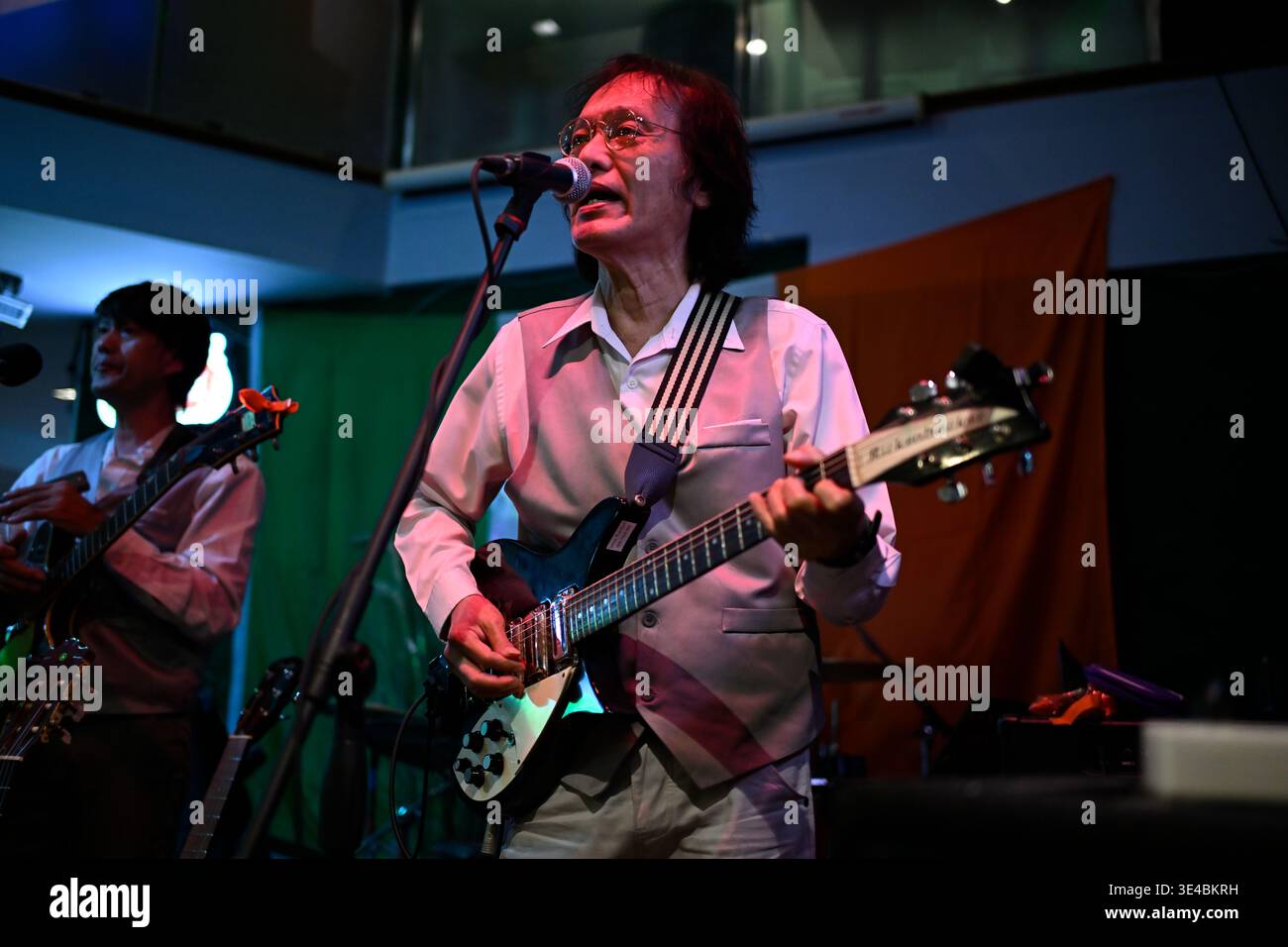 "John Lennon" performs live with the tribute band The Bangkok Beatles in Hua Hin, Thailand. Stock Photo