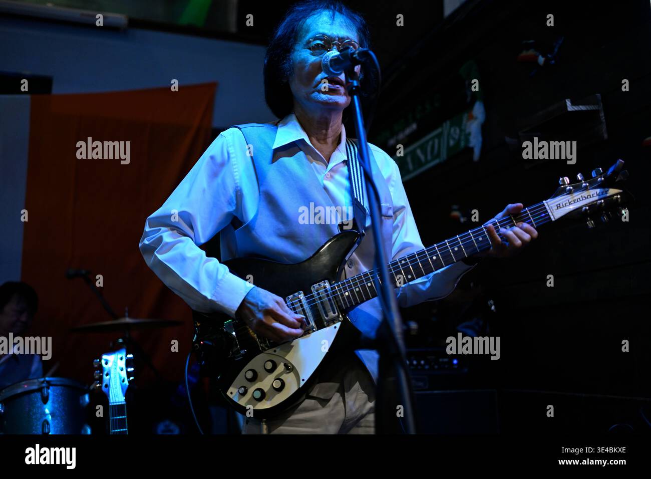 "John Lennon" performs live with the tribute band The Bangkok Beatles in Hua Hin, Thailand. Stock Photo