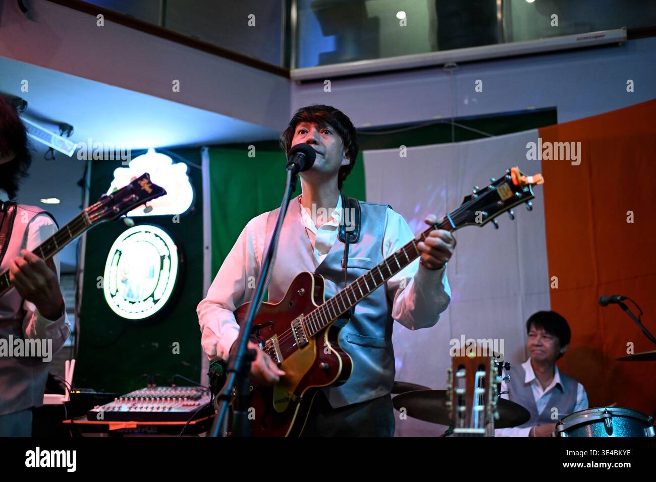 "George Harrison" performs live with the tribute band The Bangkok Beatles in Hua Hin, Thailand. Stock Photo