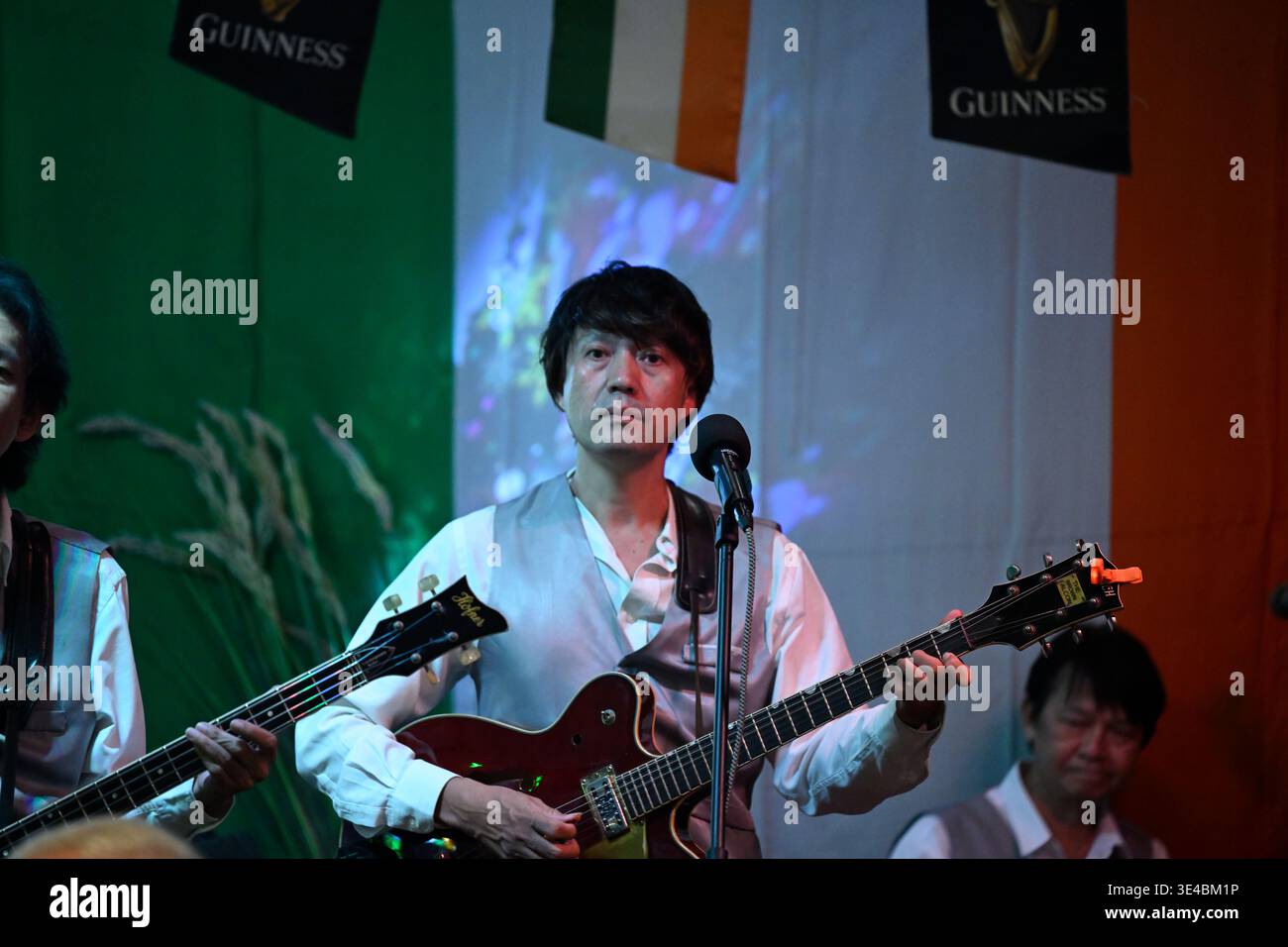 "George Harrison" performs live with the tribute band The Bangkok Beatles in Hua Hin, Thailand. Stock Photo