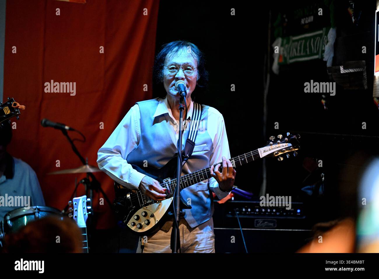 "John Lennon" performs live with the tribute band The Bangkok Beatles in Hua Hin, Thailand. Stock Photo