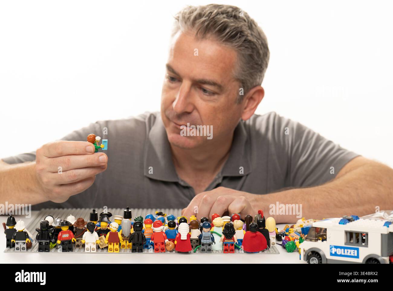 Middle aged man playing with lego Stock Photo