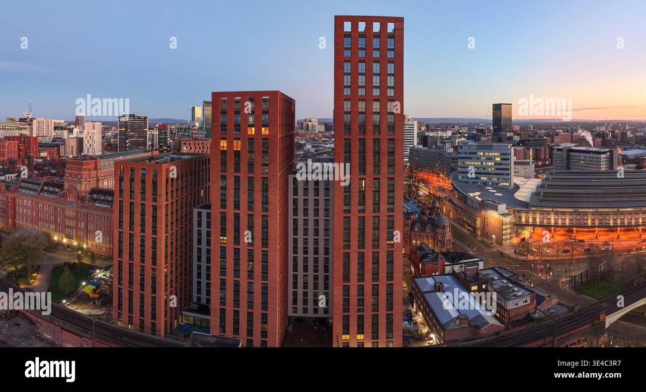 A wide aerial panorama showcasing modern red brick high-rises and ...