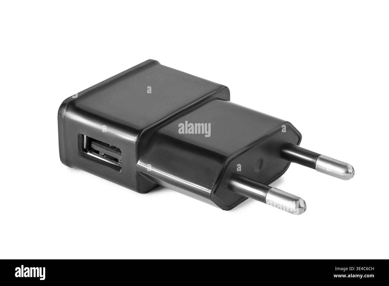 Black USB plug charging adapter lying on white background Stock Photo