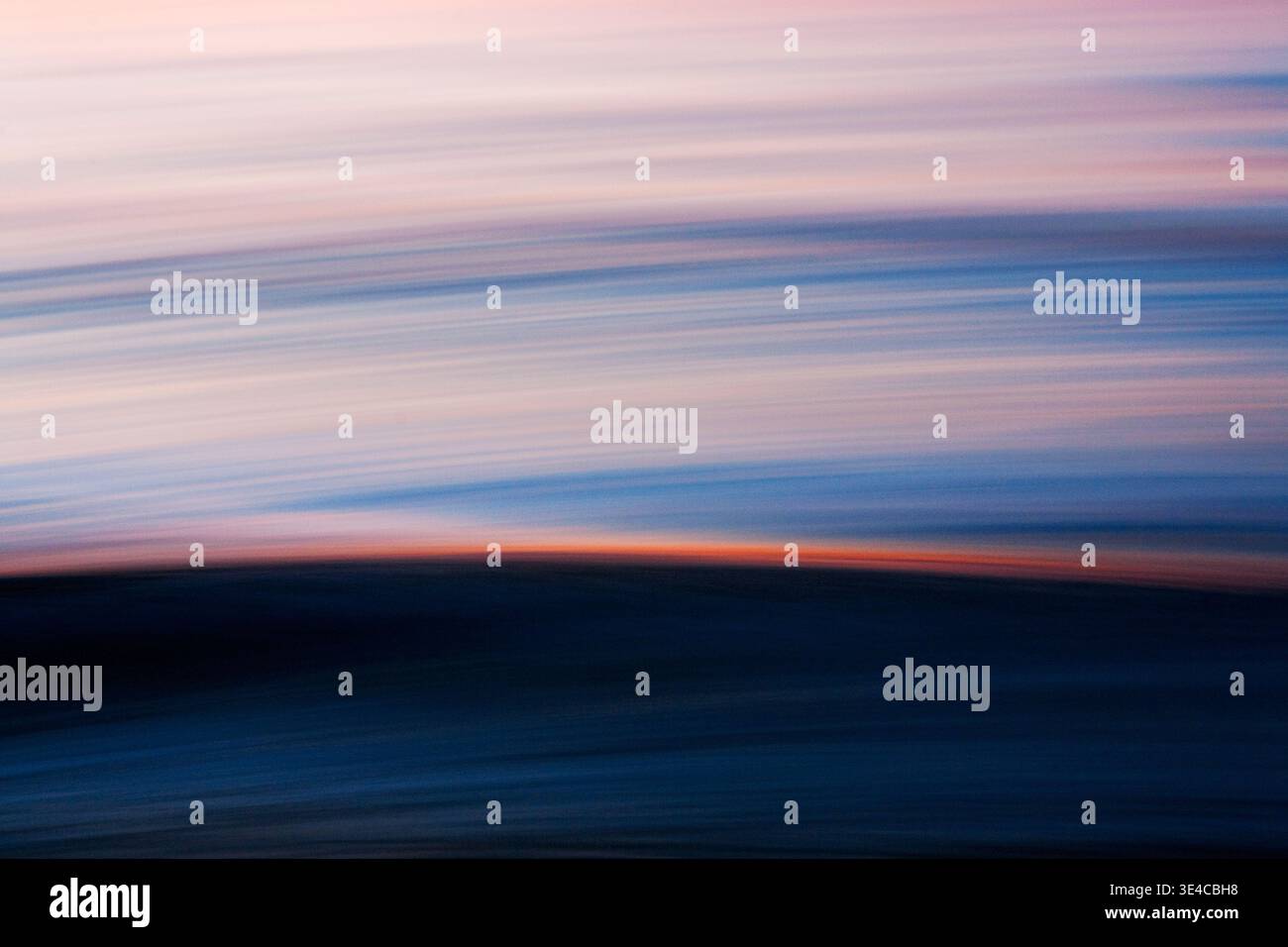 Abstract ocean motion with sunset light streak across wave Stock Photo