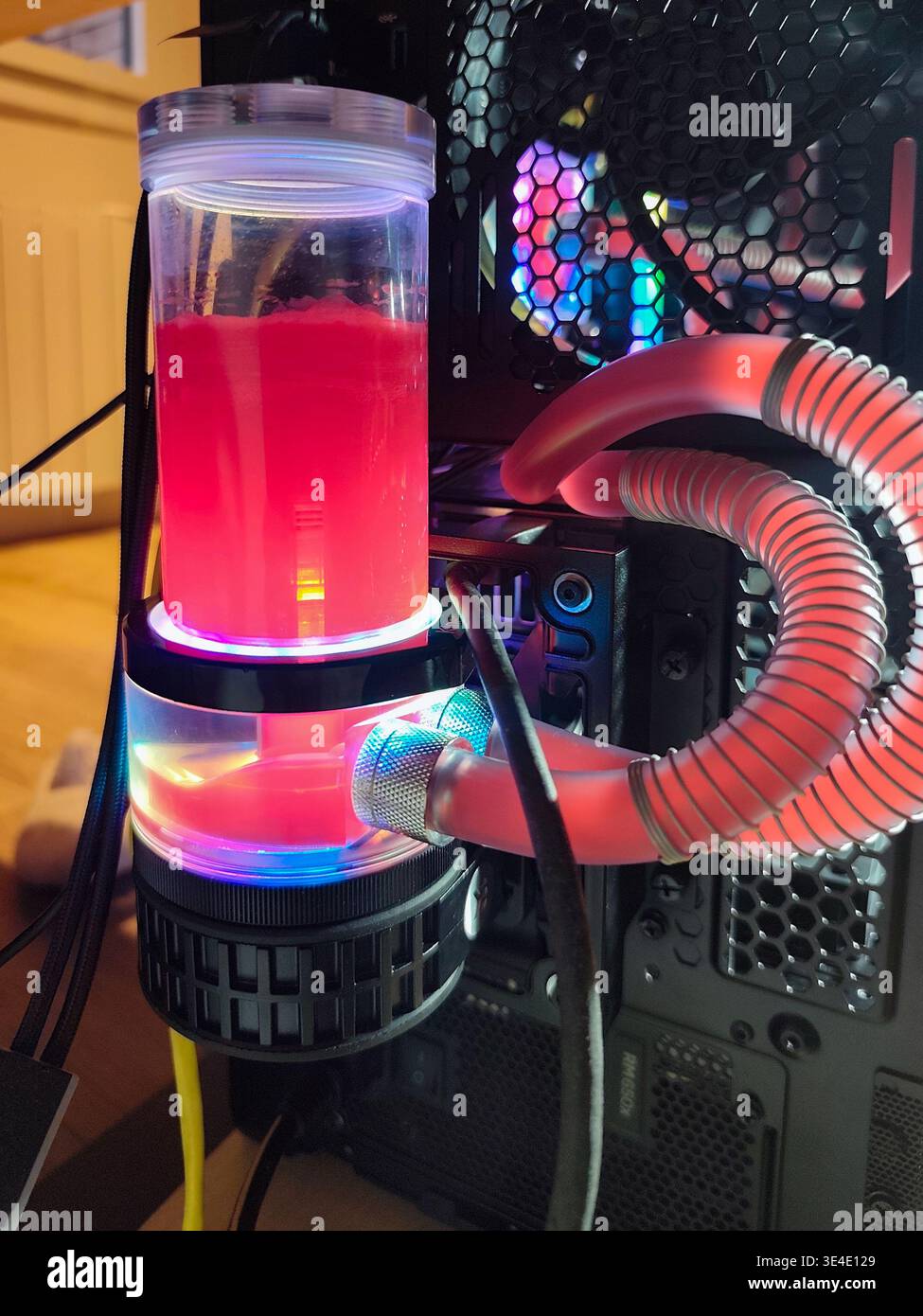 Custom liquid cooling system assembly with red coolant and RGB lighting ...
