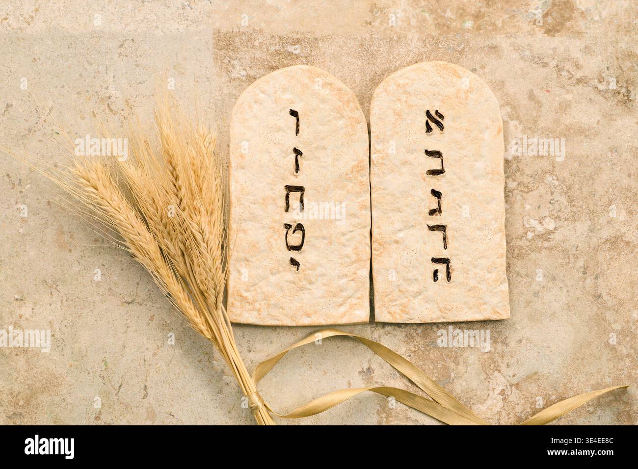 Ten commandments stone tablets with wheat for shavuot Stock Photo