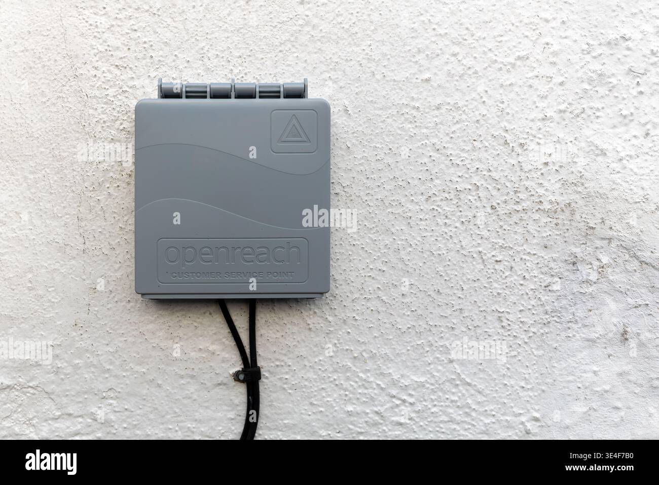 AYR, SCOTLAND - NOVEMBER 24, 2025: Wall mounted Openreach customer service point with fibre broadband cables attached on exterior building wall. Inter Stock Photo