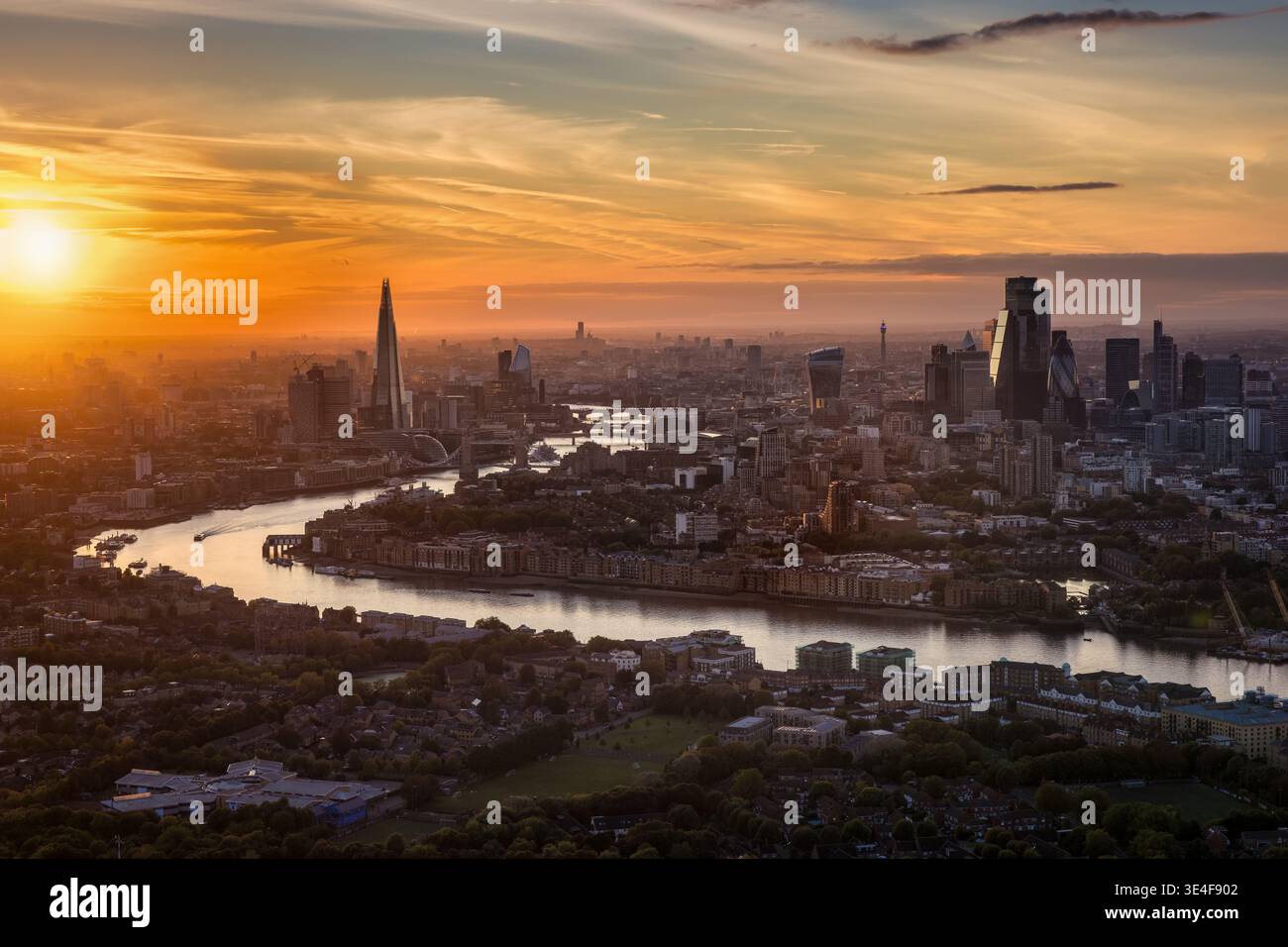 Elevated evening view of the illuminated London city skyline after a colorful sunset, England Stock Photo