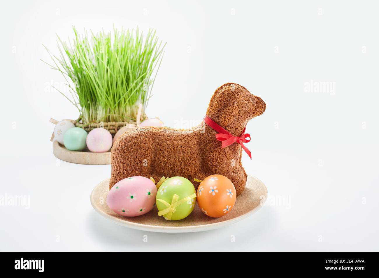 Easter lamb cake with decorated eggs and fresh grass Stock Photo