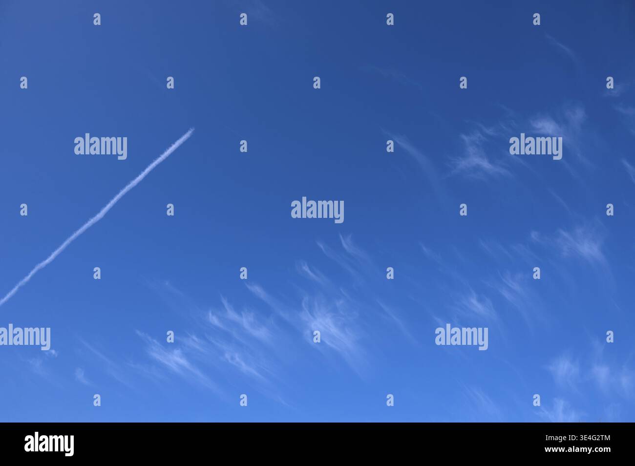 Feather clouds (cirrus) and contrails, in the blue sky, Bavaria, Germany Stock Photo
