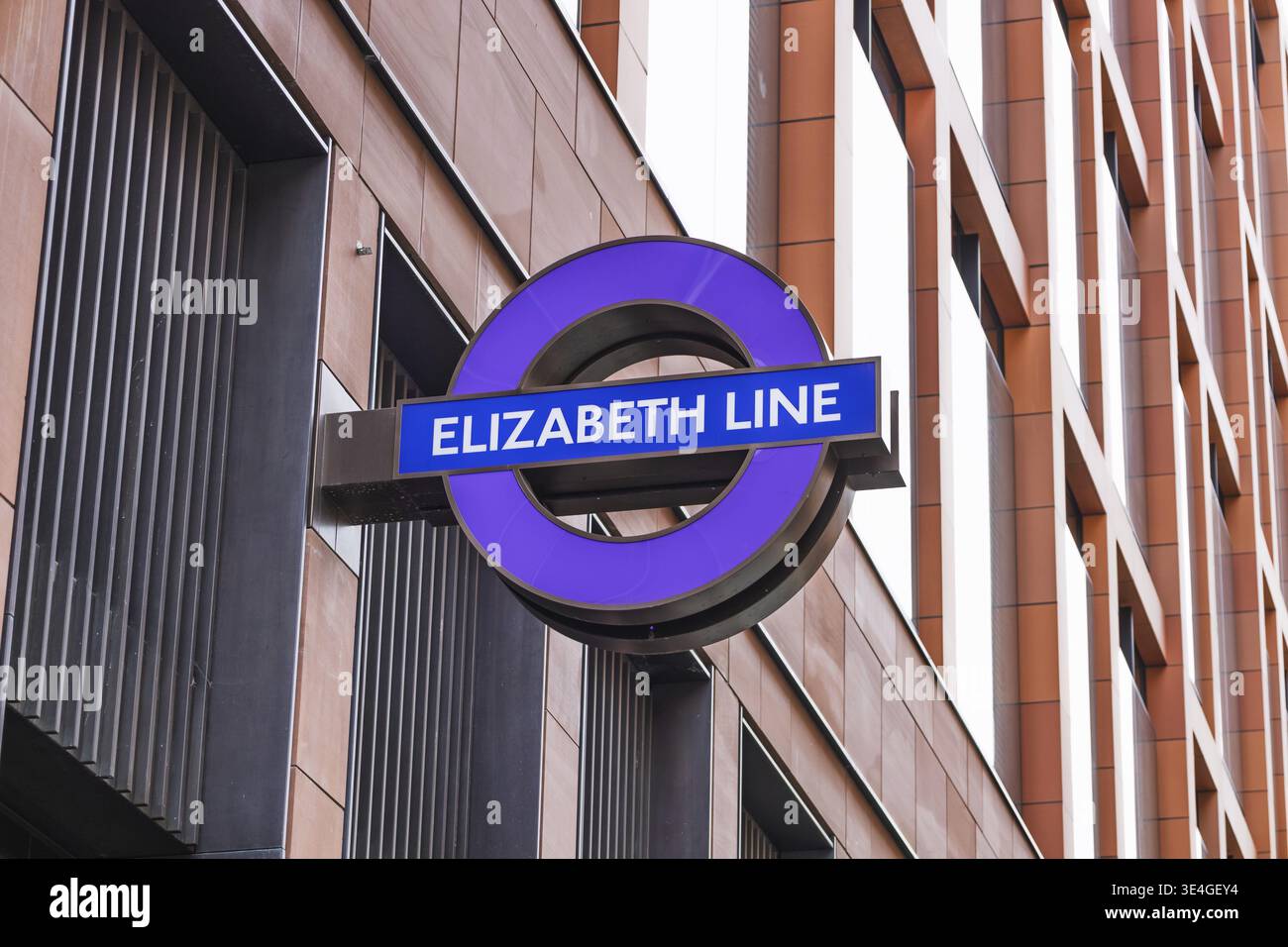 Elizabeth Line sign in London with iconic purple roundel on a modern ...