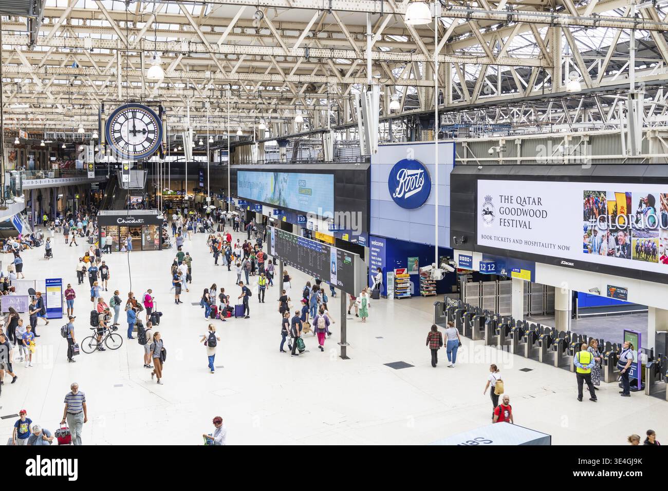 Wide view of London Waterloo Station's concourse showing commuters ...