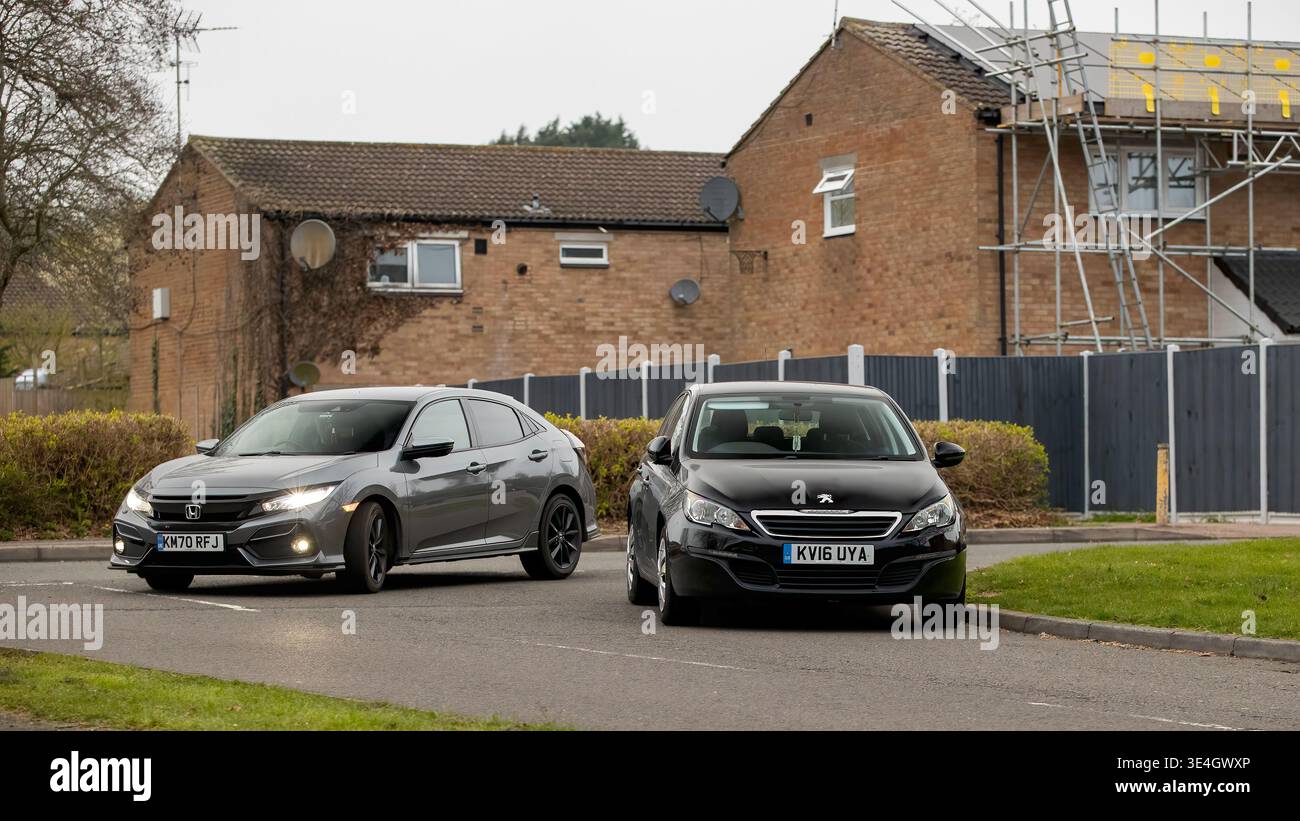 Milton Keynes,Bucks,UK - Mar 5th 2026:  car parked on the corner of a British road forcing other drivers on to the wrong side of the road and blocking Stock Photo