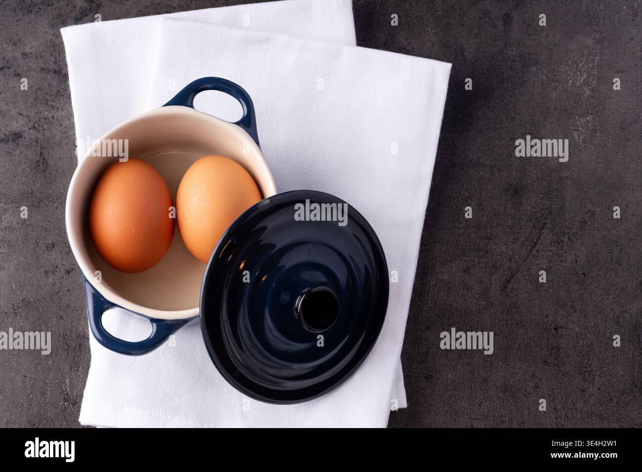 Two eggs with a crock pot in a kitchen Stock Photo