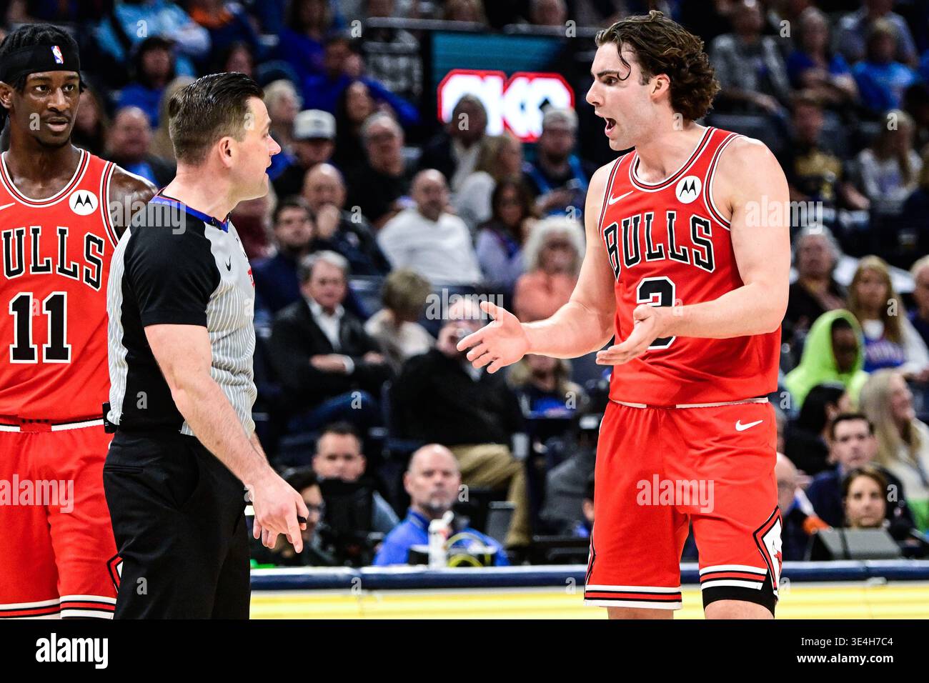 Chicago Bulls guard Josh Giddey, right, speaks with a referee during ...