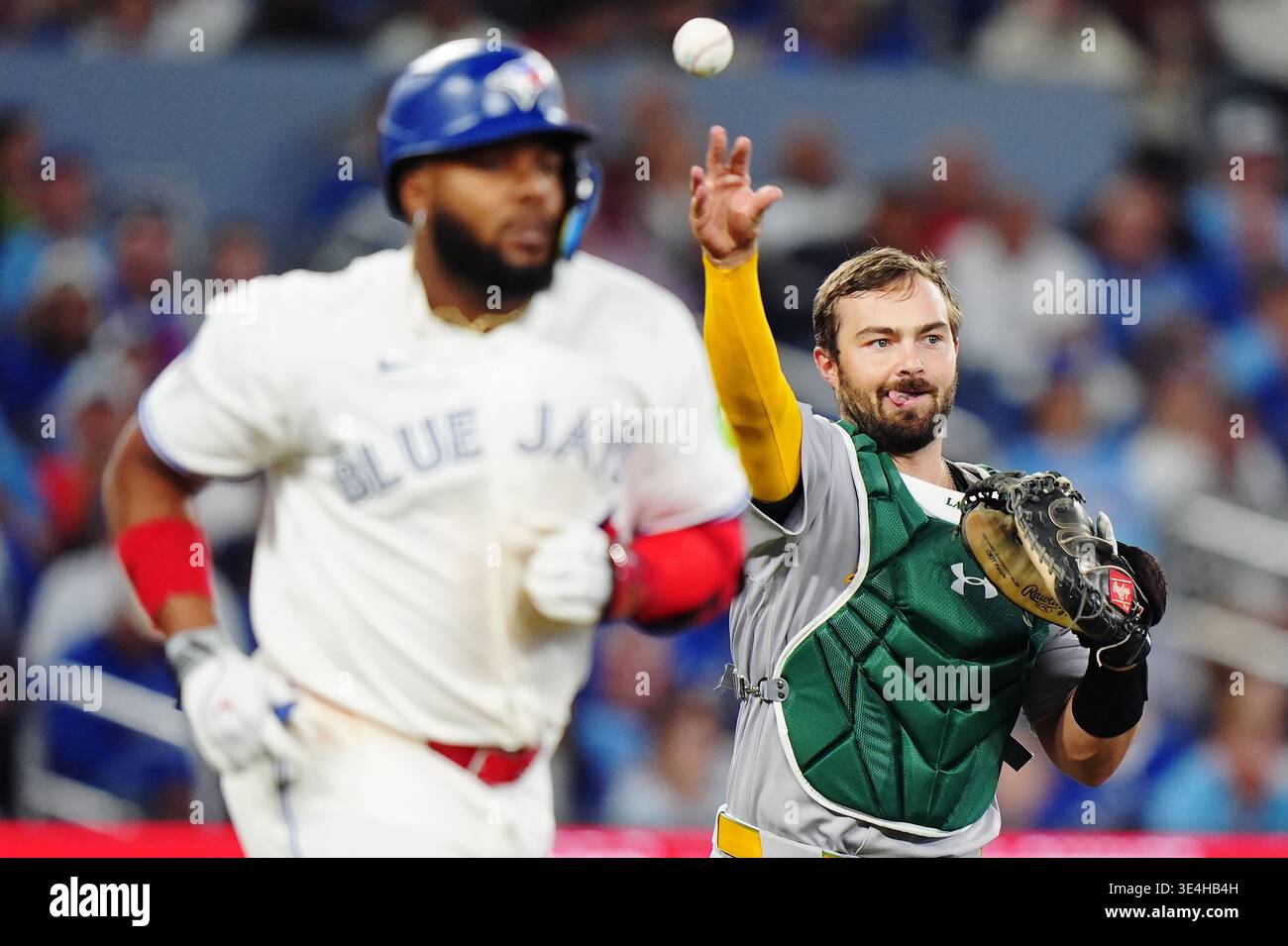 Athletics catcher Shea Langeliers (23) throws to first base to force ...