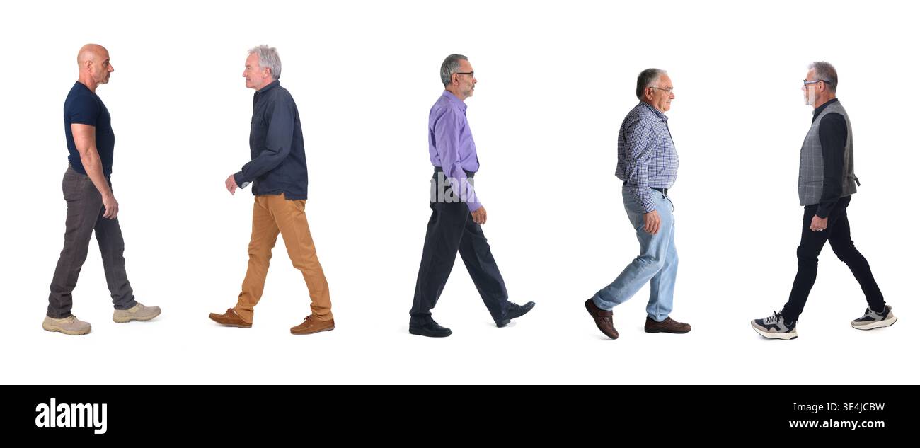 side view of a group of mature men walking on a white background Stock Photo