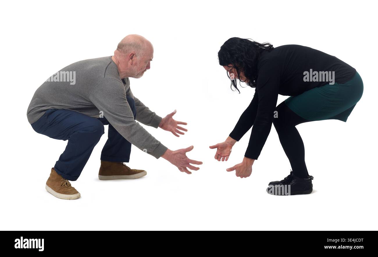 A woman and a man lifting something imaginary from the ground Stock Photo