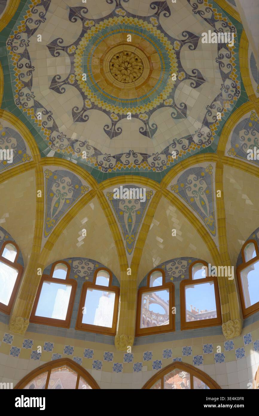 Elaborately decorated mosaic tile dome ceiling with scrollwork and bat ...