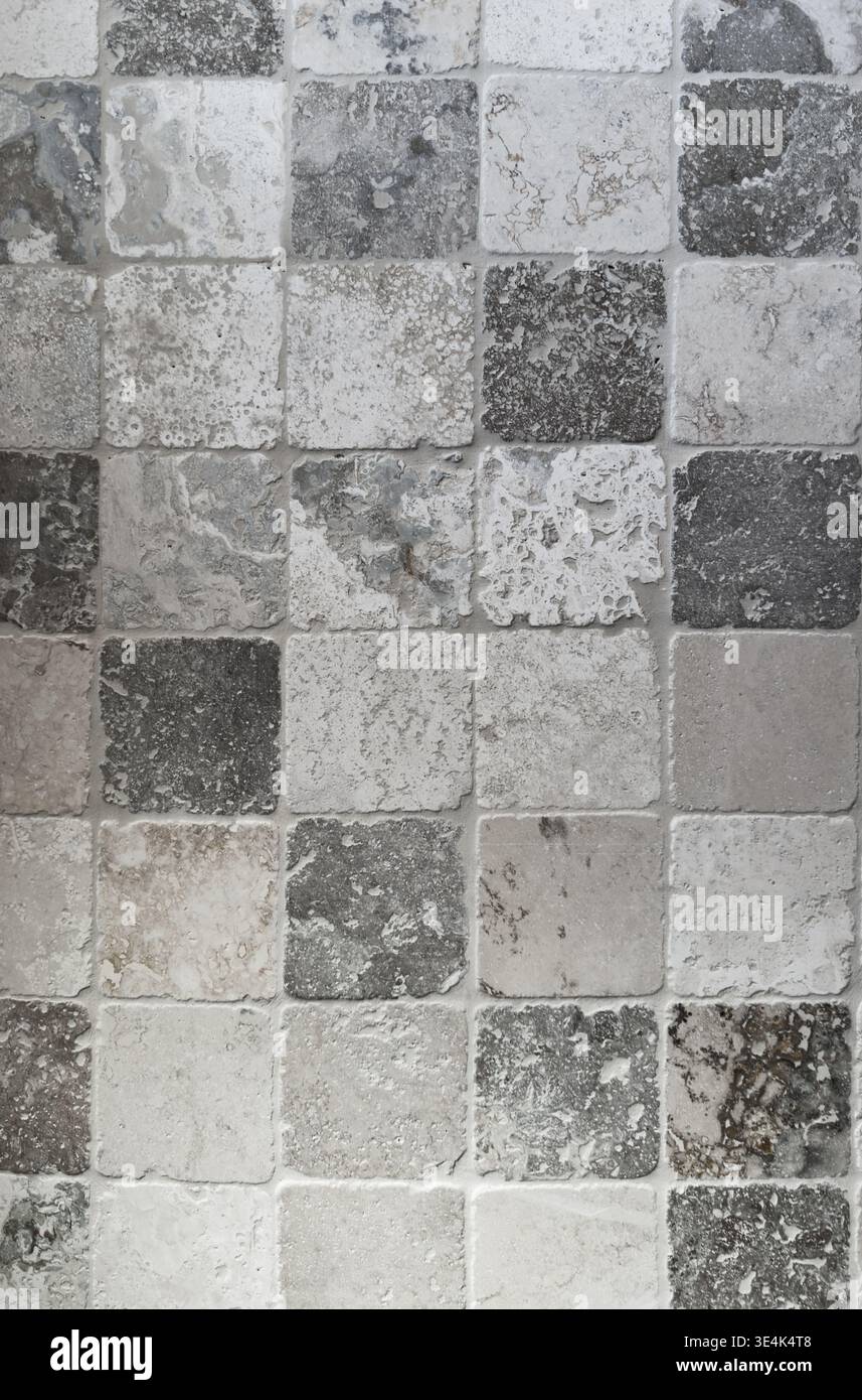 Old stone tiles pattern aged wall texture gray natural background Stock Photo