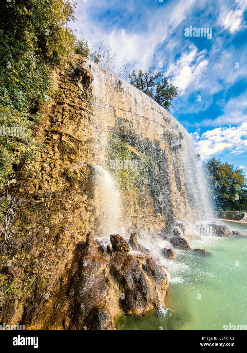 Vertical Perspective Of Cascade Du Château Waterfall In Lovely Golden Hour Sunshine – Nice, France - Smartphone Captured Stock Image