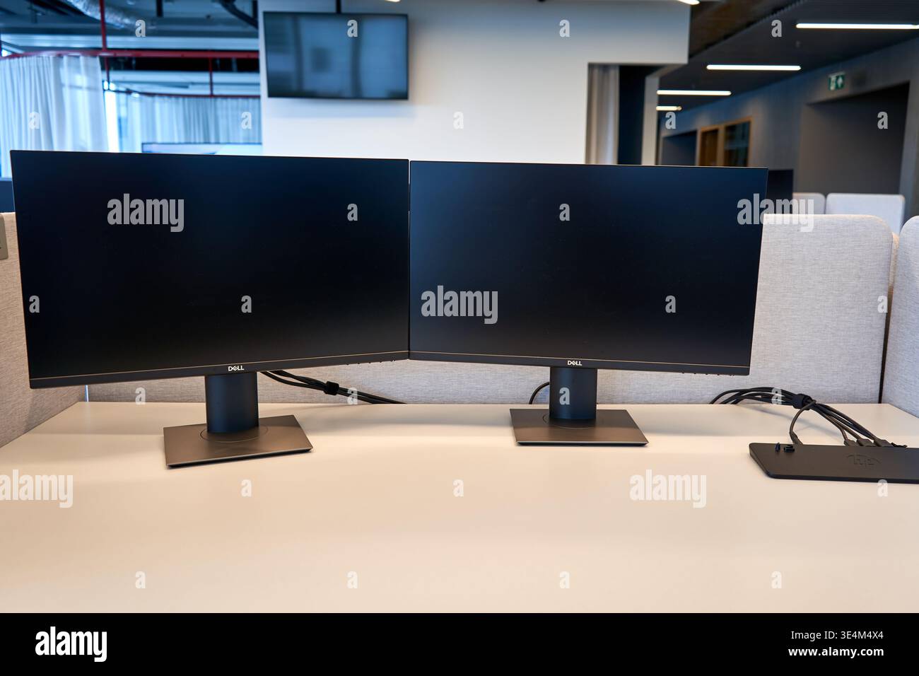 Two black Dell computer monitors positioned side by side on a white ...