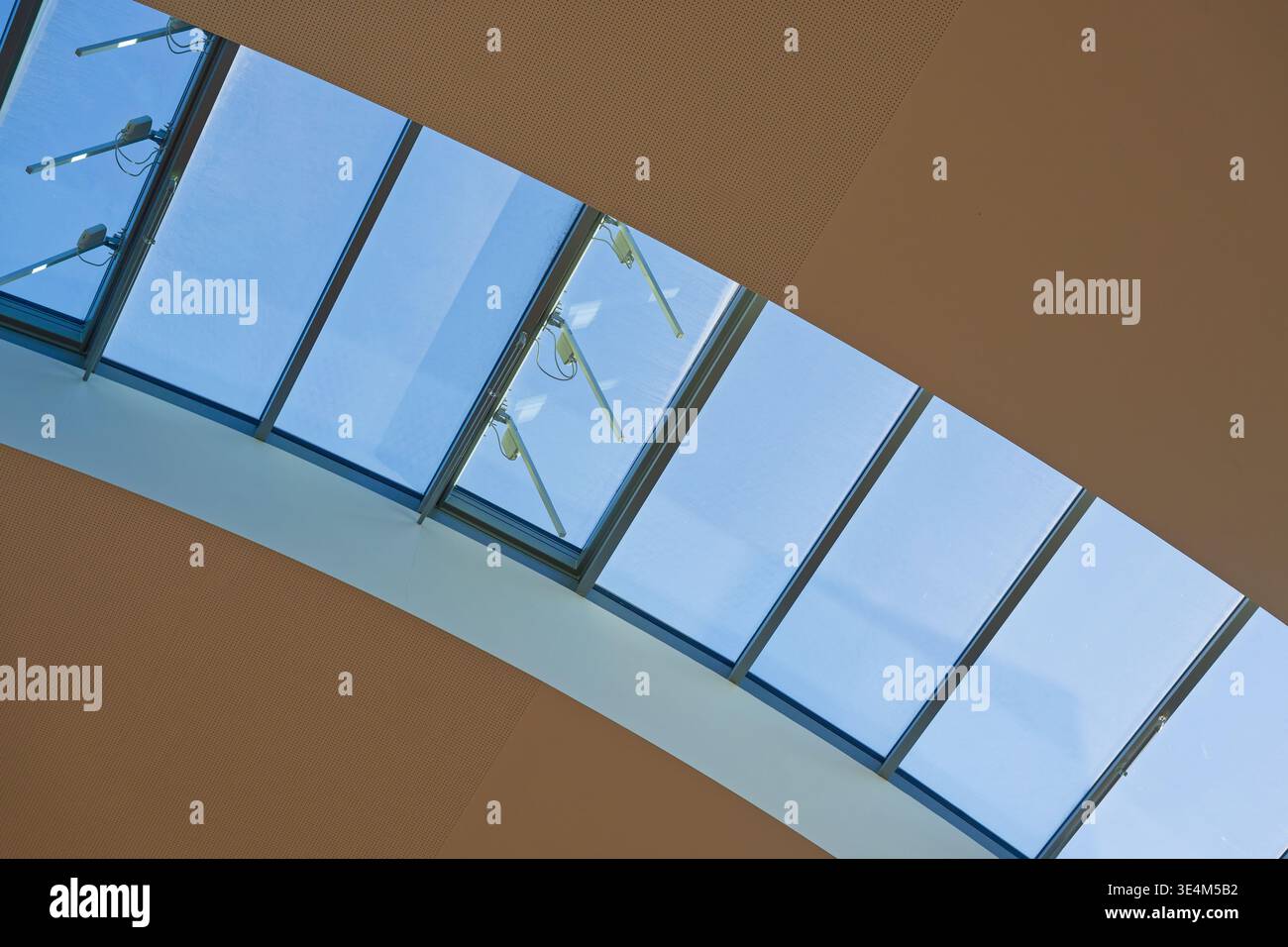 A modern skylight window with multiple glass panels set in a ceiling ...