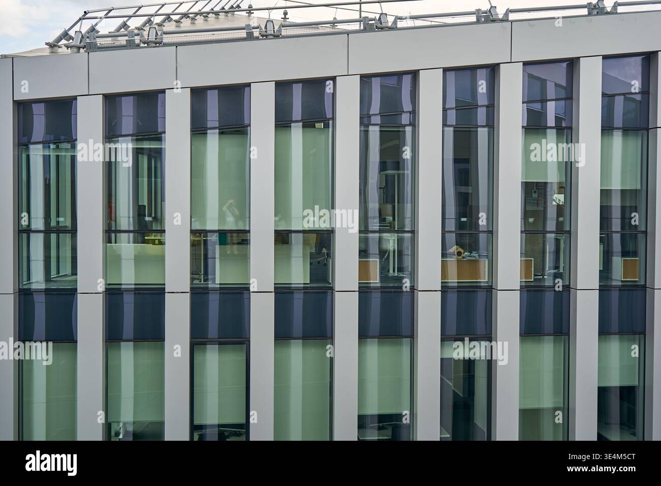 Close-up view of a modern office building facade featuring a repetitive ...